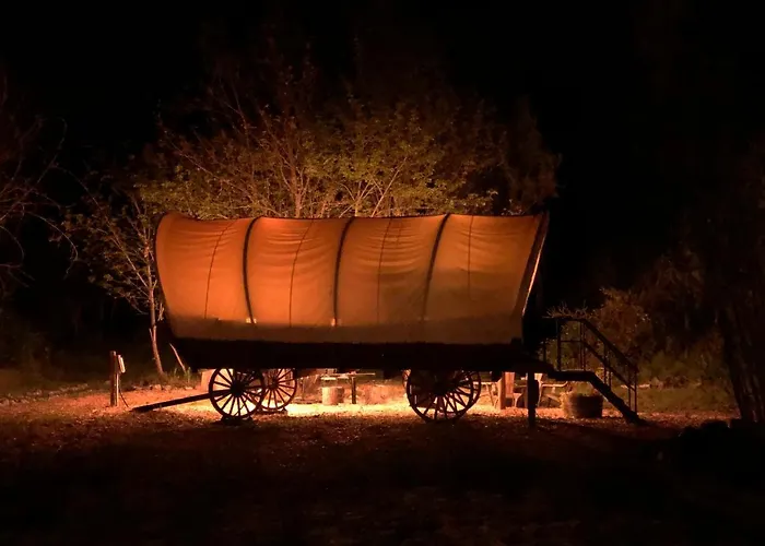 Cozy Wild West Covered Wagon Next To River